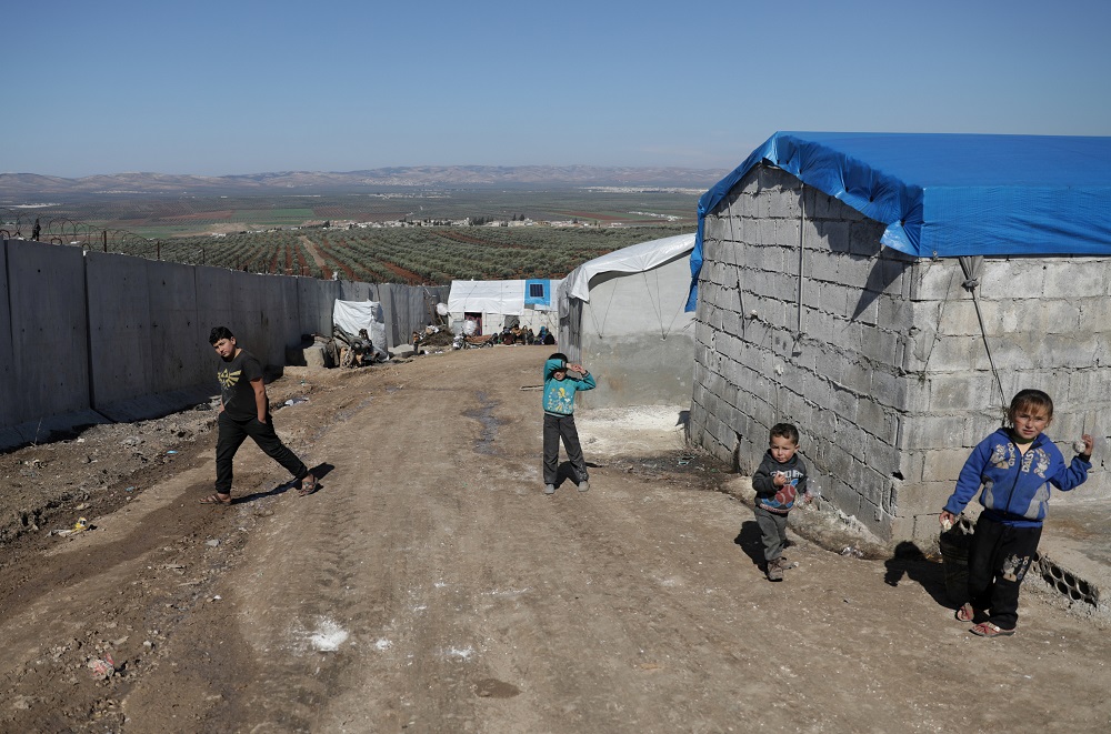 Internally displaced Syrian children walk near the wall in Atmah IDP camp, located near the border with Turkey, Syria February 26, 2020. u00e2u20acu2022 Reuters pic