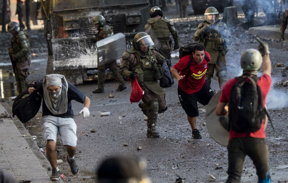 Demonstrators are chased by police during clashes following a protest against Chilean President Sebastian Pinerau00e2u20acu2122s government in Santiago, on January 31, 2020. u00e2u20acu201d AFP pic