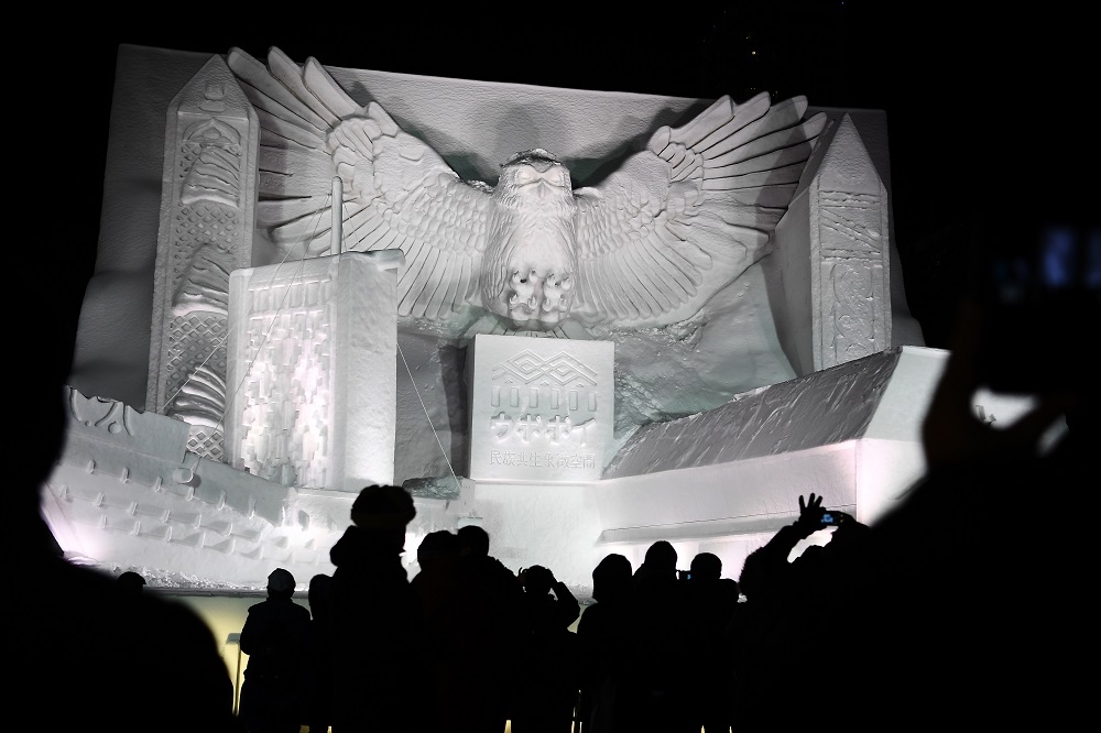 A giant snow sculpture supported by Hokkaido Television Broadcasting representing a u00e2u20acu02dckotankoro kamuyu00e2u20acu2122 (Blakistonu00e2u20acu2122s fish owl) watching over the National Ainu Museum is seen after sundown during the Sapporo Snow Festival February 4, 2020. u00e2u20acu201d AFP pic 