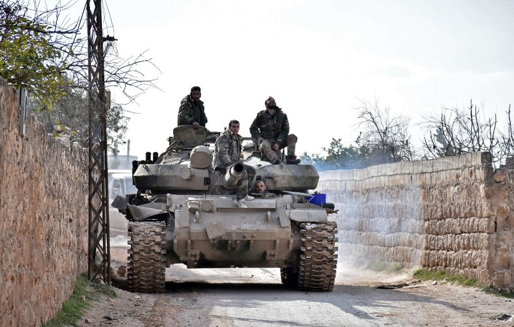 Handout picture released by the official Syrian Arab News Agency on February 3, 2020, shows Syrian soldiers riding atop a T-27 tank in an area southwest of Saraqeb during their assault on Idlib region. u00e2u20acu201d SANA pic via AFP