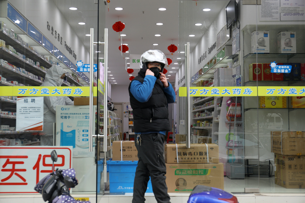 A man wearing a face mask stands outside a pharmacy following an outbreak of the novel coronavirus in Wuhan, Hubei province, China February 7, 2020. u00e2u20acu201d Reuters picnn