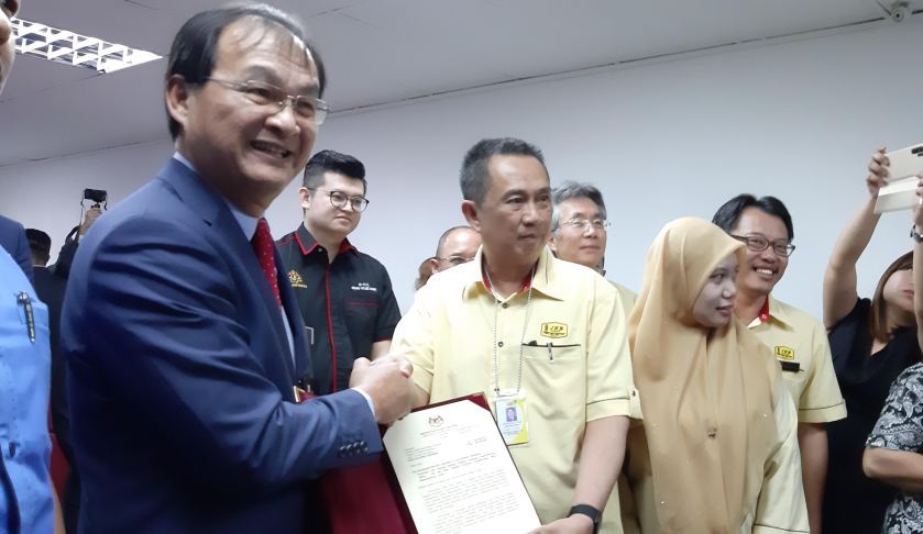 Works Minister Baru Bian (left) handing over letter of appointment to state PWD director Datuk Zuraimi Sabki for state PWD as superintending officer, February 20, 2020. u00e2u20acu2022 Picture by Sulok Tawie