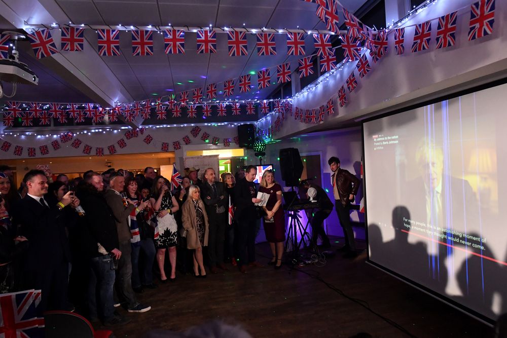 Revellers watch as British Prime Minister Boris Johnson addresses the nation at a Brexit Celebration party in Morley, northern England on January 31, 2020, the day that the UK formally leaves the European Union. u00e2u20acu201d AFP pic