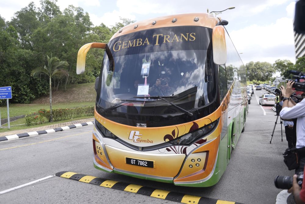 A bus ferrying Barisan Nasional and PAS MPs arrives at Istana Negara February 25, 2020. u00e2u20acu2022 Picture Miera Zulyana