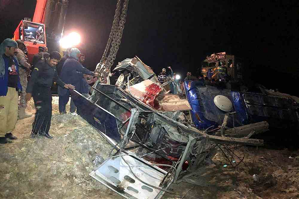 Pakistani officials remove the wreckage of a bus after a passenger train hit the bus in Sukkur February 28, 2020. u00e2u20acu201d AFP pic