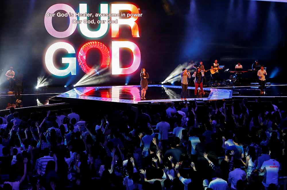 Worshippers attend a church service at the City Harvest Church in Singapore March 1, 2014. u00e2u20acu201d Reuters pic