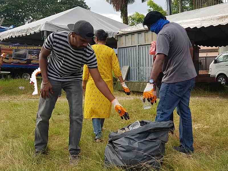 Volunteers throwing rubbish into the bags provided. — Picture courtesy of JK Wicky