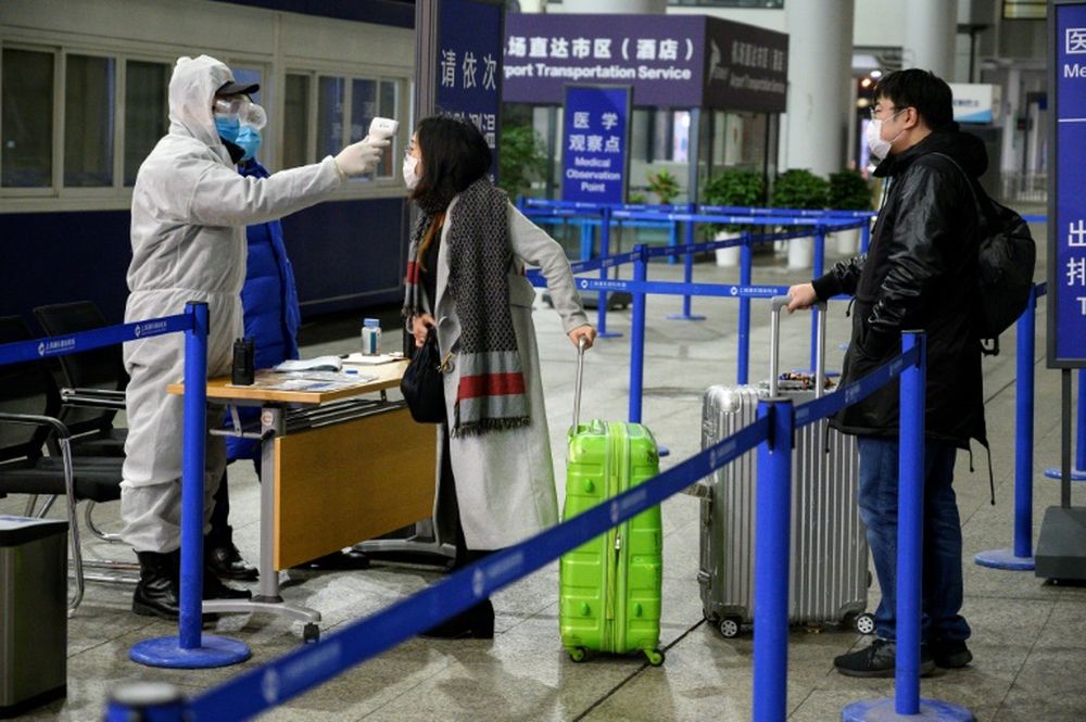 Passengers arriving at Shanghai Pudong International Airport have their temperature taken, February 4, 2020. u00e2u20acu201d AFP pic
