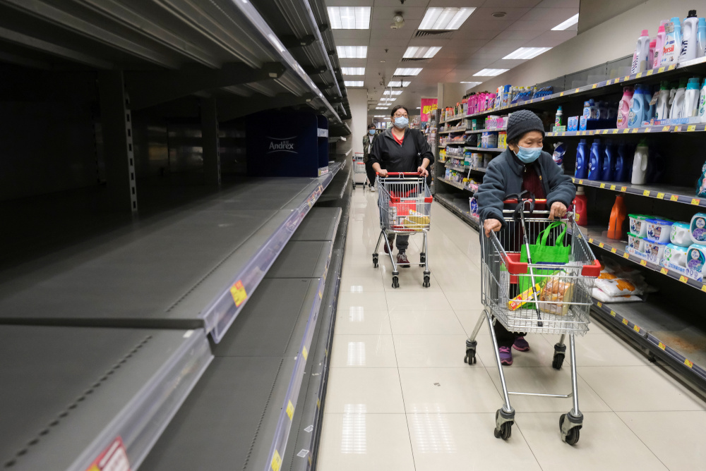 Customers wear masks as they walk past empty toilet paper shelves at a supermarket, following the outbreak of a new coronavirus, in Hong Kong, China February 6, 2020. u00e2u20acu201d Reuters pic 