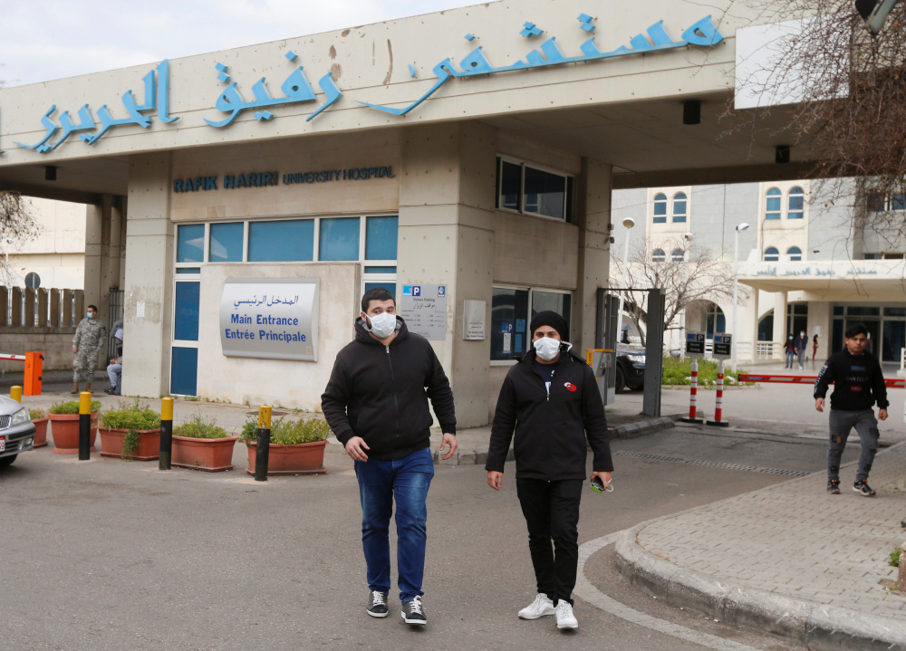 People wearing face masks walk outside Rafik Hariri hospital, where Lebanonu00e2u20acu2122s first Covid-19 case is being quarantined, in Beirut, Lebanon February 21, 2020. u00e2u20acu201d Reuters pic 
