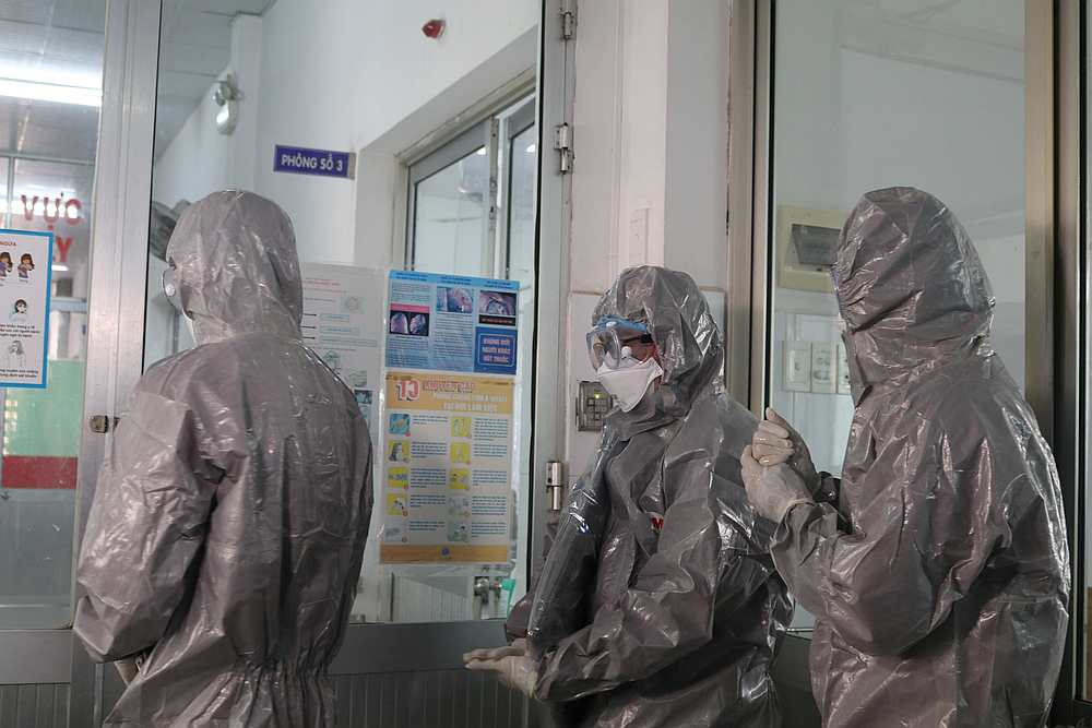 Doctors wearing protective suits walk to an isolated section at Cho Ray hospital in Ho Chi Minh city, Vietnam January 30, 2020. u00e2u20acu201d Dinh Hang/VNA pic via Reuters