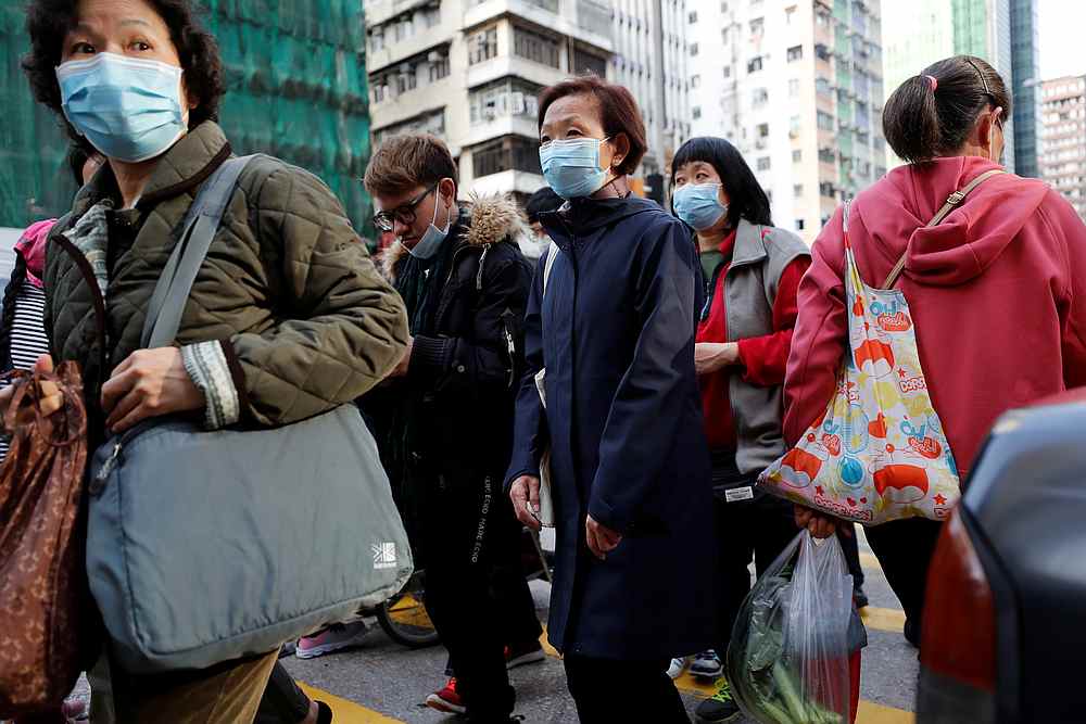 People wear protective masks as they walk a downtown street following the outbreak of Covid-19, in Hong Kong, February 17, 2020. u00e2u20acu201d Reuters pic