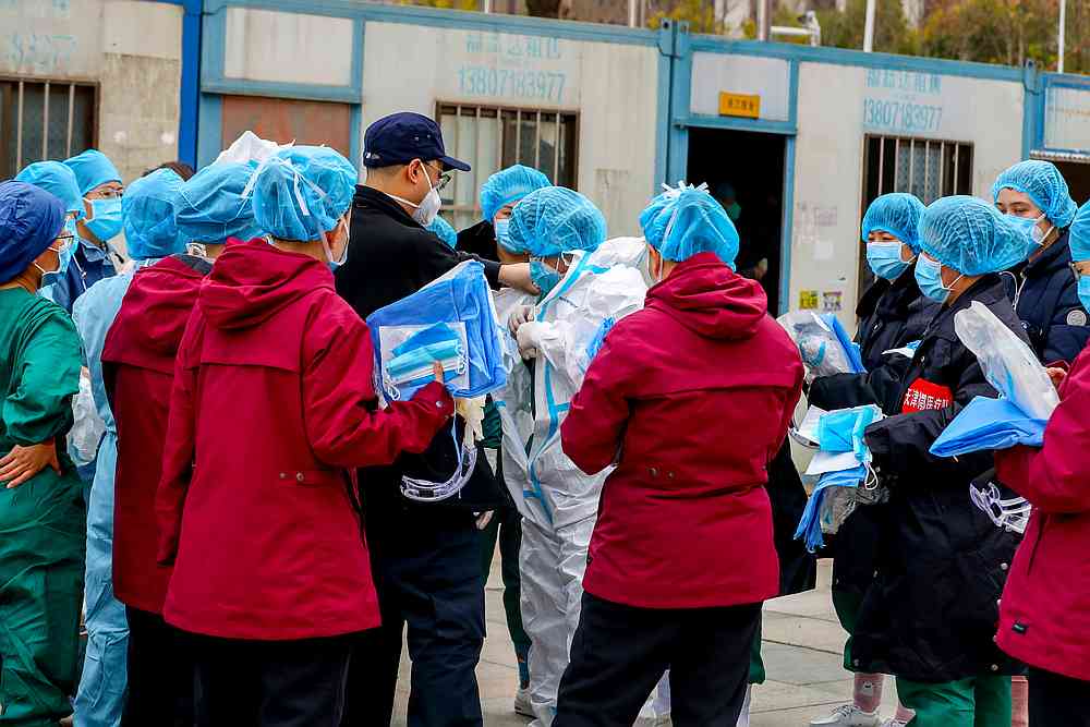 A medical worker puts on a protective suit before entering a sports centre which has been converted into a makeshift hospital to treat Covid-19 patients in Wuhan, Hubei province, China February 12, 2020. u00e2u20acu201d Reuters pic