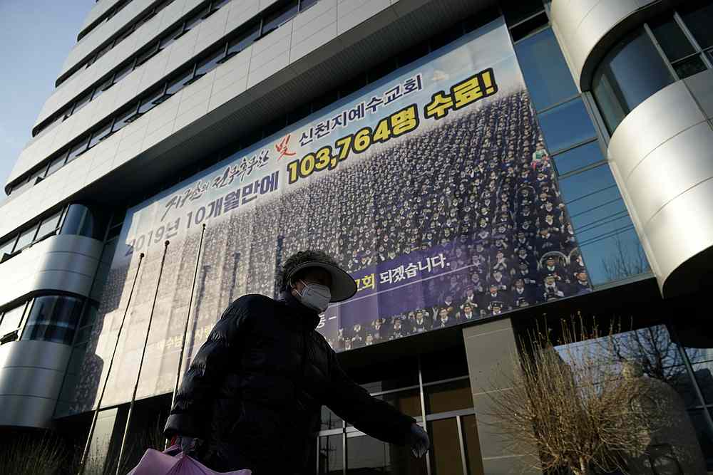 A woman wearing a mask  walks past a branch of the Shincheonji Church of Jesus the Temple of the Tabernacle of the Testimony in Daegu, South Korea February 21, 2020. u00e2u20acu201d Reuters pic