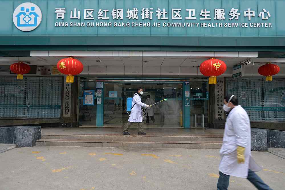 A doctor disinfects the entrance of a community health service centre in Qingshan district of Wuhan, Hubei province, China February 2, 2020. u00e2u20acu201d China Daily via Reuters