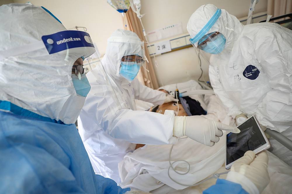 Medical workers in protective suits attend to a patient inside an isolated ward of Wuhan Red Cross Hospital in Wuhan, Hubei province, China February 16, 2020. u00e2u20acu201d China Daily pic via Reuters