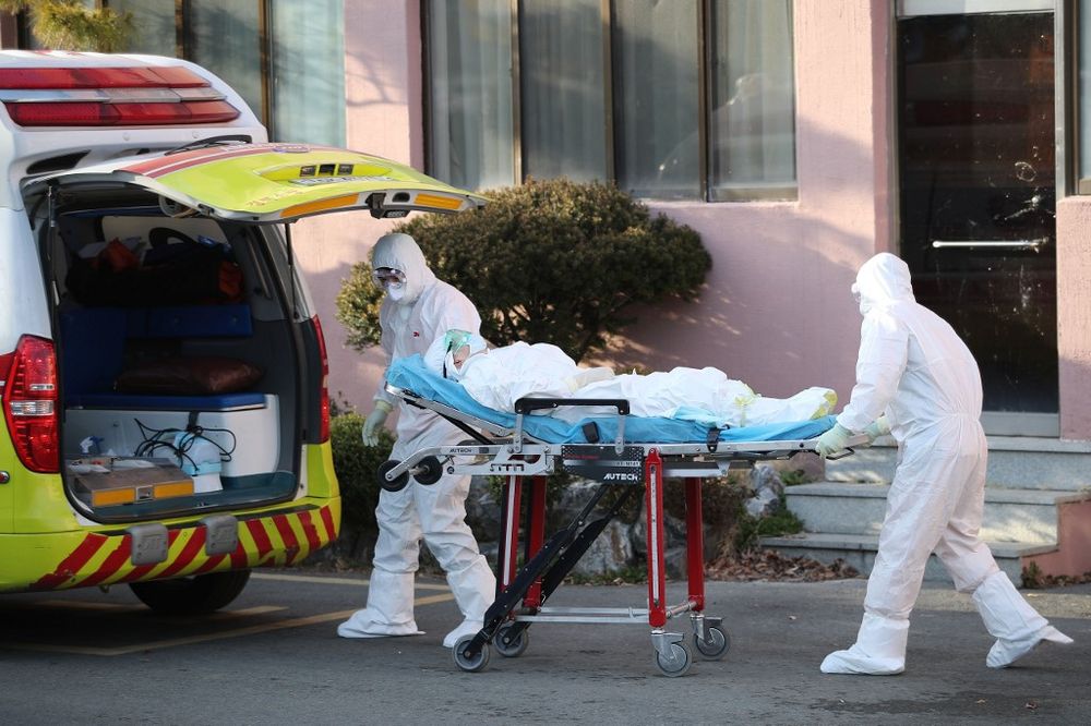 Medical workers wearing protective gear transfer a suspected coronavirus patient (centre) to another hospital from Daenam Hospital, in Cheongdo county near the city of Daegu, South Korea, February 21, 2020. u00e2u20acu201d AFP pic