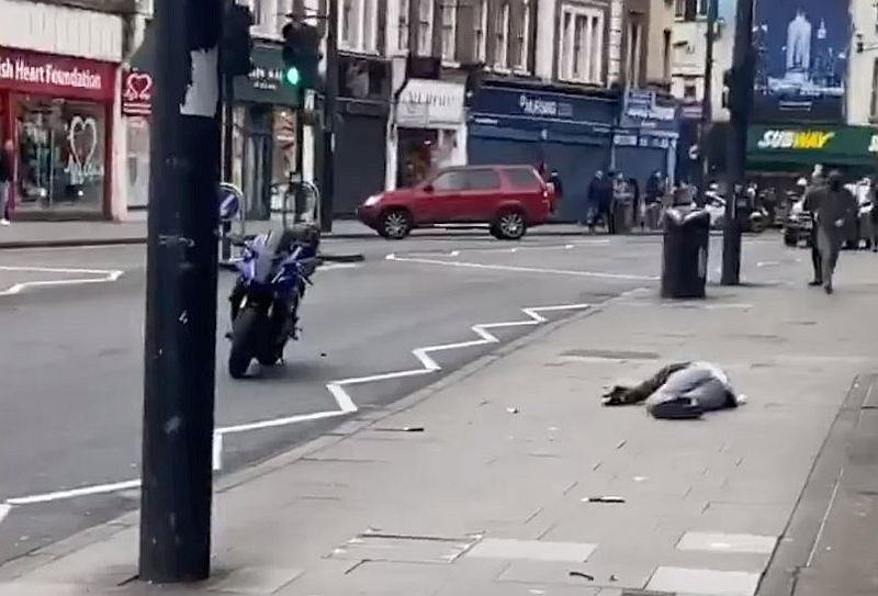A man shot by the police after a stabbing attack lies on the pavement in Streatham, south London, Britain February 2, 2020. u00e2u20acu201d Sulaiman Kamara/social media image via Reuters