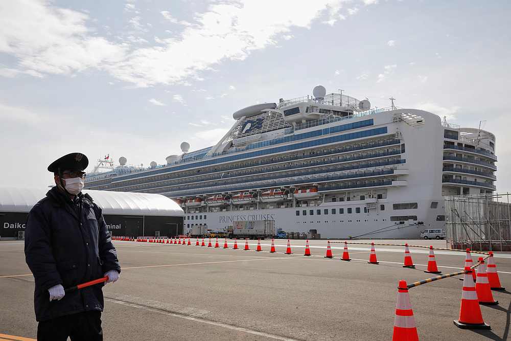 A man wearing a mask stands guard at the port next to the cruise ship Diamond Princess at Daikoku Pier Cruise Terminal in Yokohama, south of Tokyo, Japan February 12, 2020. u00e2u20acu201d Reuters pic