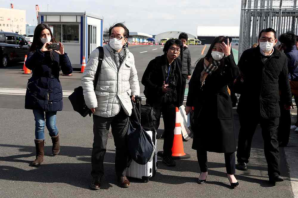 Passengers wearing face masks walk out from the cruise ship Diamond Princess at Daikoku Pier Cruise Terminal in Yokohama, south of Tokyo, Japan February 19, 2020. u00e2u20acu201d Reuters pic
