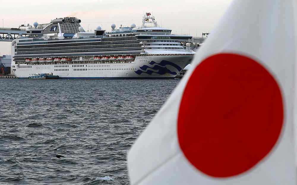 Cruise ship Diamond Princess lies at anchor while workers and officers prepare to transfer passengers who tested positive for Covid-19,  in Yokohama, south of Tokyo, Japan, February 12, 2020. u00e2u20acu201d Reuters pic