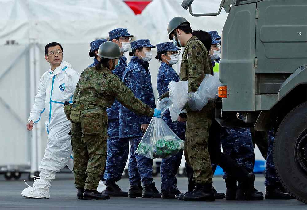 Japan Self-Defence Force officers in protective suits carry bags with items near the cruise ship Diamond Princess at Daikoku Pier Cruise Terminal in Yokohama, south of Tokyo February 10, 2020. u00e2u20acu201d Reuters pic