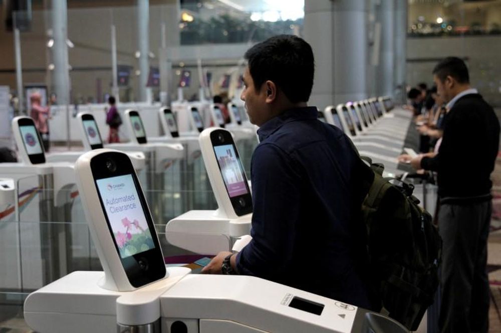A passenger passes through an automated immigration control gate at Changi airportu00e2u20acu2122s Terminal 4 in Singapore April 30, 2018. u00e2u20acu201d Reuters pic