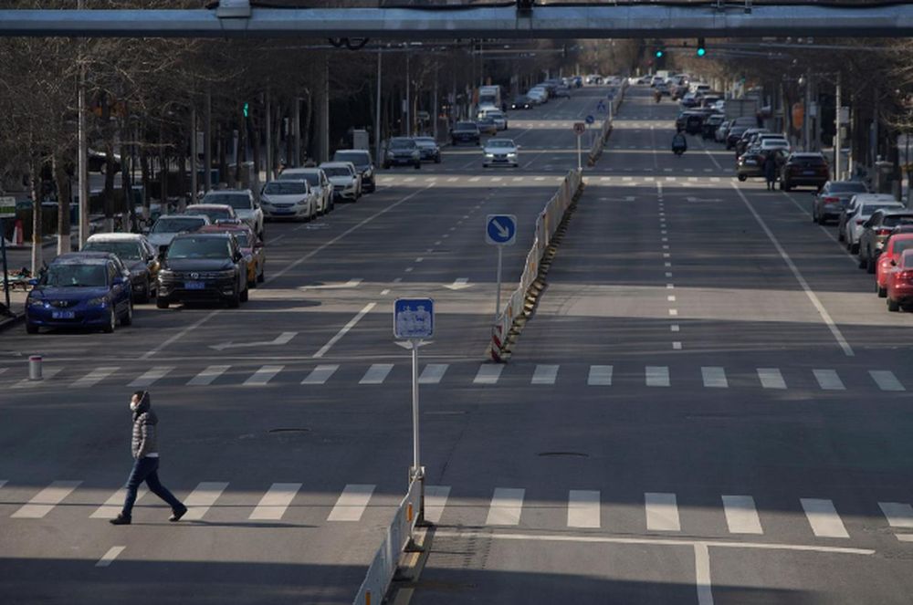 A man wearing a face mask crosses a road, as the country is hit by an outbreak of the novel coronavirus, in Beijing, China February 15, 2020. u00e2u20acu201d Reuters pic