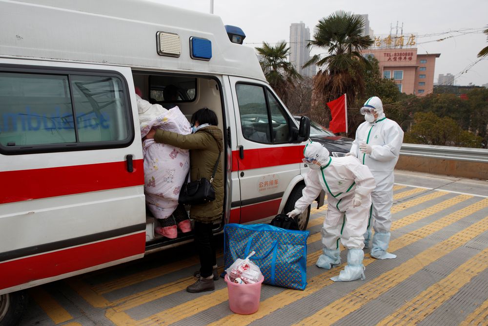 Hospital staff in protective garments pick up a leukaemia patient who arrived from the Hubei province exclusion zone at a checkpoint at the Jiujiang Yangtze River Bridge in Jiujiang, Jiangxi province, China, February 1, 2020. — Reuters pic