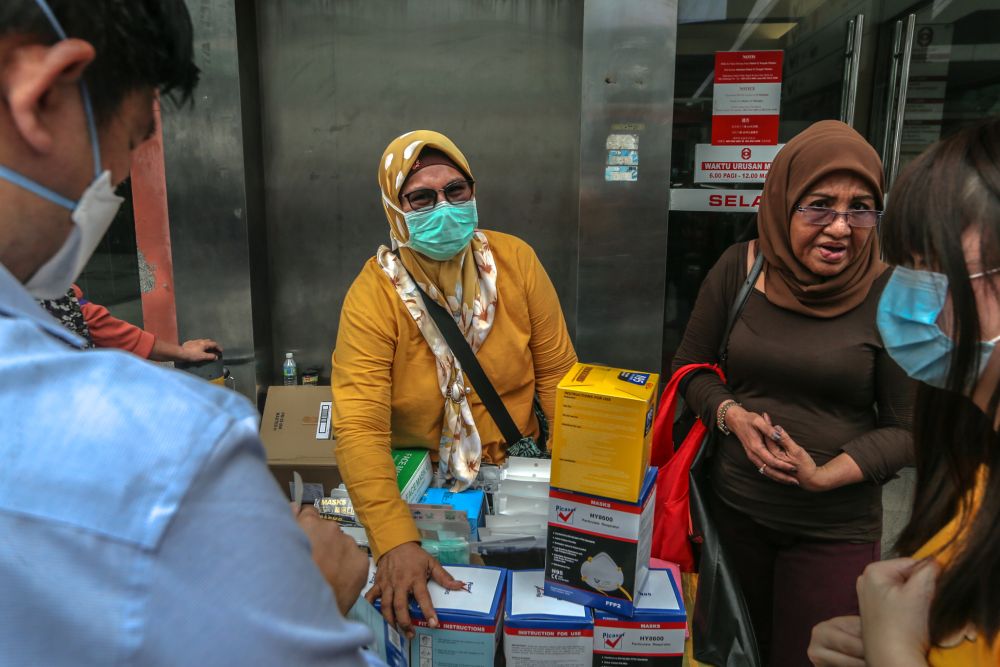 A vendor sells face masks in Bukit Bintang, Kuala Lumpur February 10, 2020. u00e2u20acu201d Picture by Firdaus Latif