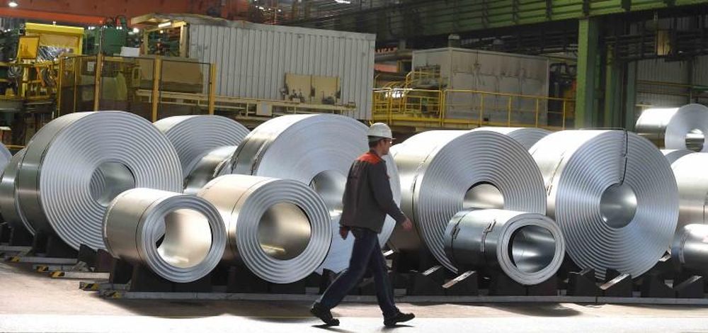 An employee passes rolls of steel in a depot at the plant of German steel company Salzgitter AG in Salzgitter, Lower Saxony March 17, 2015. u00e2u20acu201d Reuters pic