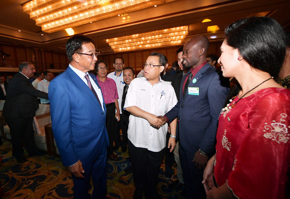 Sarawak Minister of Tourism, Arts, Culture, Youth and Sports, Datuk Abdul Karim Rahman Hamzah speaks to youth from Africa and the Philippines during the launch of the Global Youth Forum in Kuching, Sarawak February 3, 2020. Also present is Angkasa preside