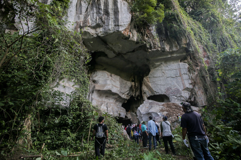 A group of volunteers from the Ventrex Outdoor Recreation conduct a conservation and cleaning programme at the Gua Mat Surat in Ipoh after illegal idols were found in the cave. u00e2u20acu201d Picture by Farhan Najib