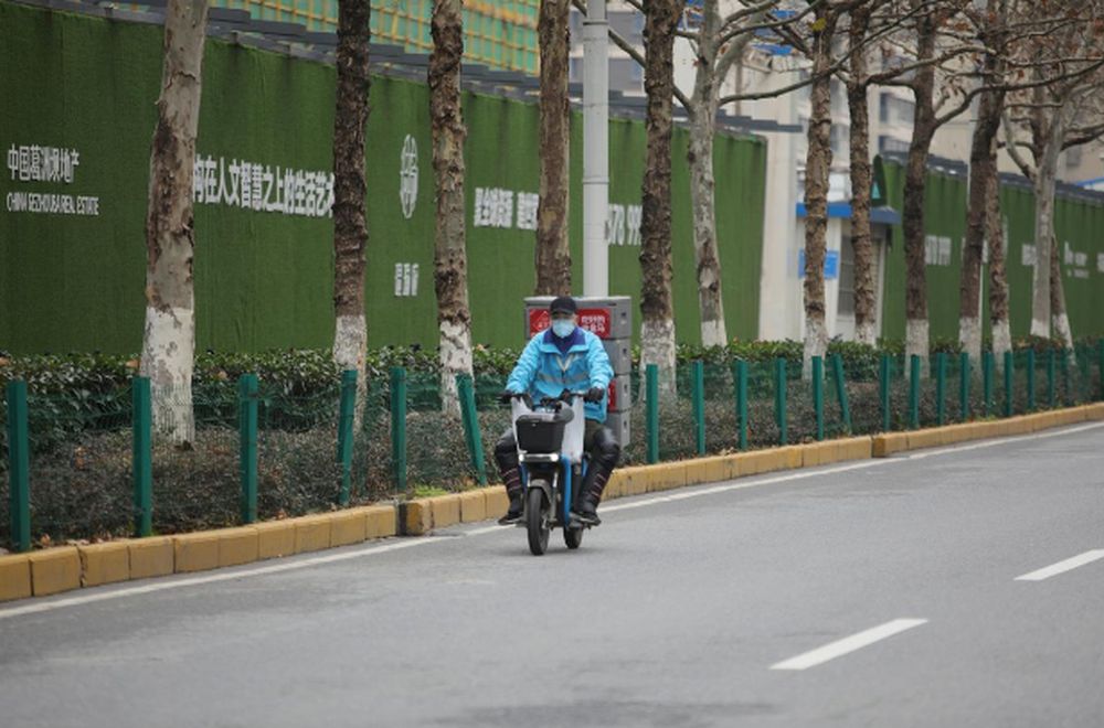 A delivery worker for Alibabau00e2u20acu2122s Hema Fresh supermarket chain rides an electric bike following an outbreak of the novel coronavirus in Wuhan, Hubei province, China February 11, 2020. u00e2u20acu201d Reuters pic