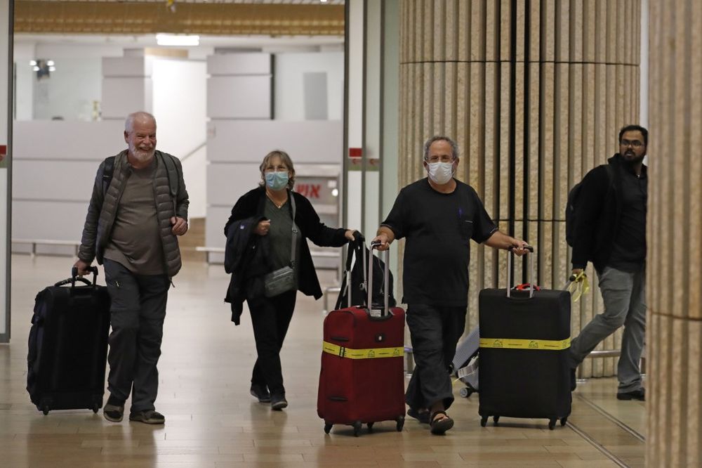 Passengers wearing protective masks walk at the arrival hall of Ben Gurion International Airport on February 22, 2020. Israel refused to allow some 200 non-Israelis to disembark from a plane which arrived from South Korea. u00e2u20acu201d AFP pic