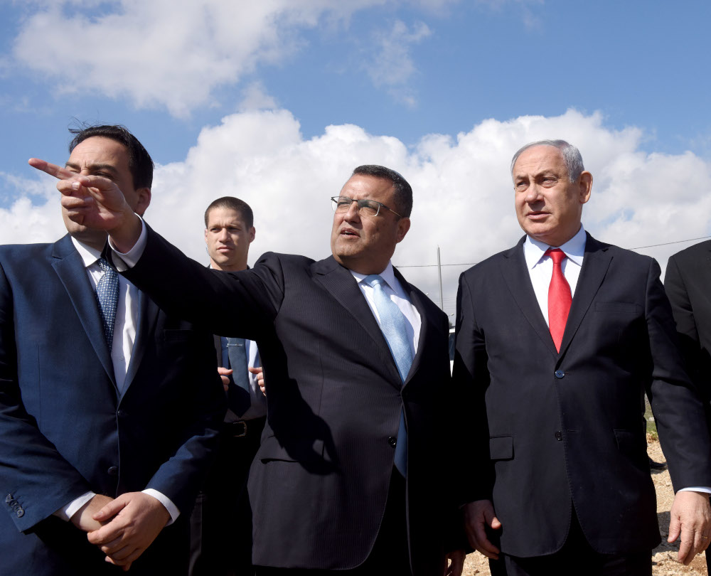 Israeli Prime Minister Benjamin Netanyahu (right) watches from an overview the Israeli settlement of Har Homa (background) February 20, 2020. u00e2u20acu201d AFP pic 