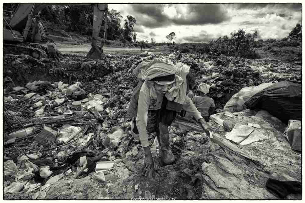 An Orang Asli woman is seen scavenging through the landfill. ― Picture by SC Shekar