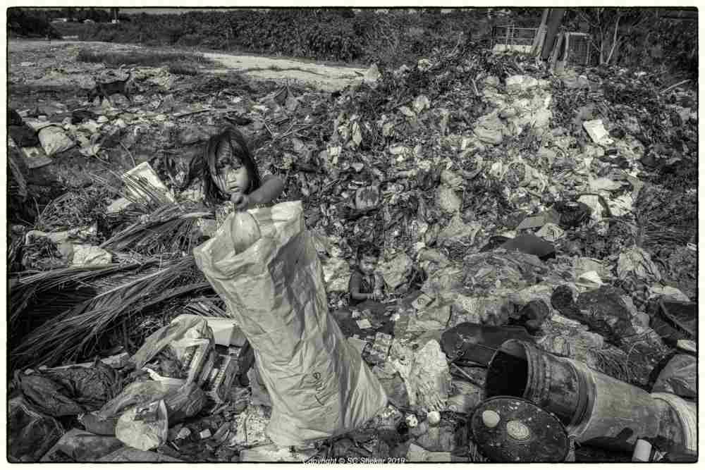 A child is seen scavenging through the landfill. ― Picture by SC Shekar
