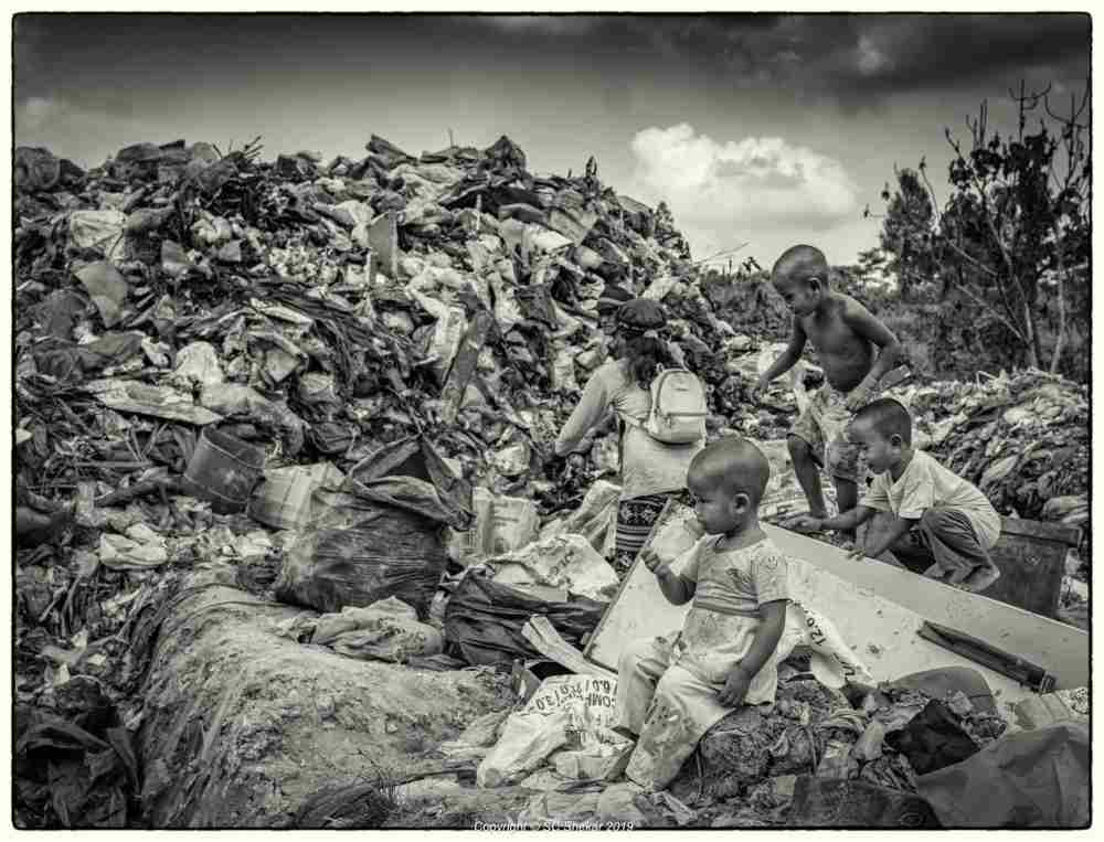 Children, including toddlers, rummaging through garbage in the landfill together with their parents. ― Picture by SC Shekar