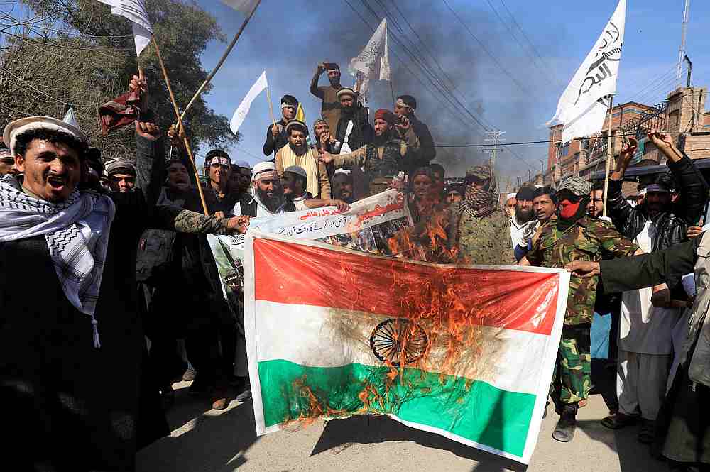 People chant slogans as they set a banner with India's flag on fire during a rally to mark Kashmir Solidarity Day, in Peshawar, Pakistan February 5, 2020. u00e2u20acu201d Reuters pic