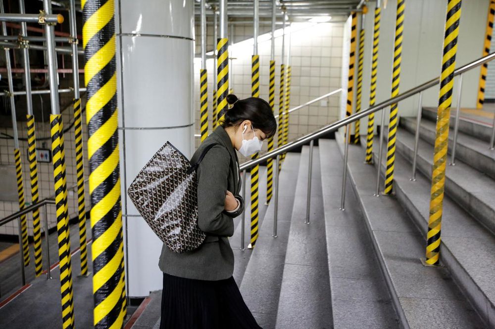 A woman wearing a mask as a preventive measure against the coronavirus walks up the steps at a subway station in Seoul, South Korea, February 20, 2020. u00e2u20acu201d Reuters pic