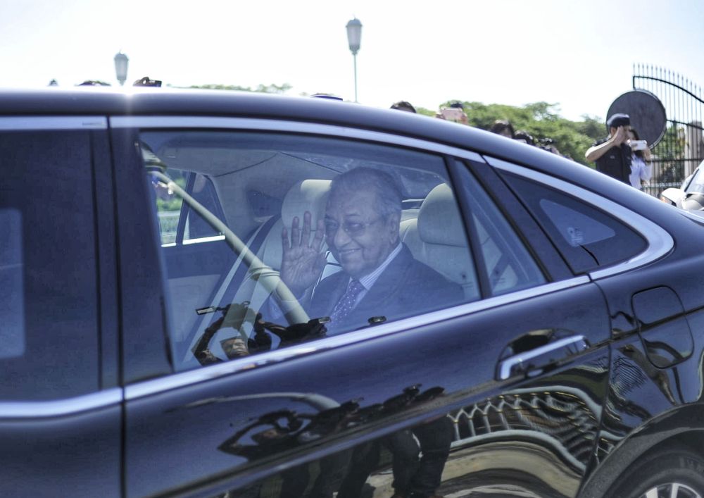 Interim prime minister Tun Dr Mahathir Mohamad waves to reporters as he leaves Perdana Putra February 27, 2020. u00e2u20acu201d Picture by Shafwan Zaidon
