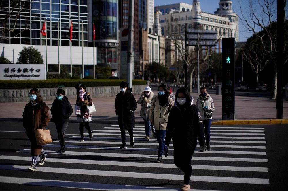 Pedestrians wearing face masks cross a road, as the country is hit by an outbreak of the novel coronavirus, in Shanghai, China February 17, 2020. u00e2u20acu201d Reuters pic