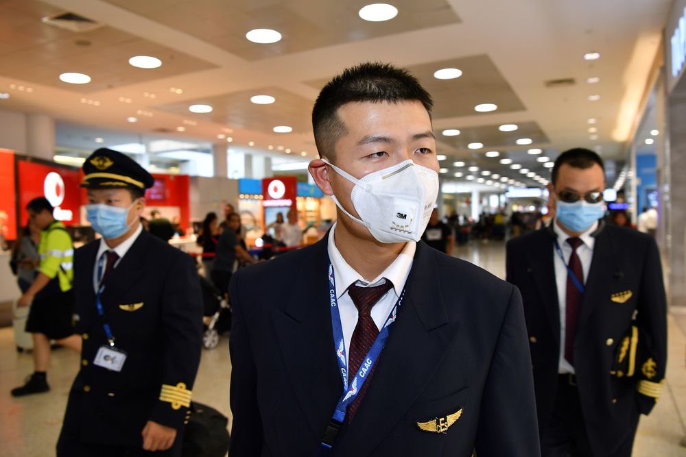 China Eastern Airlines flight crew wear protective masks on arrival at Sydney International Airport in Sydney, Australia, January 23, 2020. u00e2u20acu201d AAP Image/Joel Carrett via Reuters