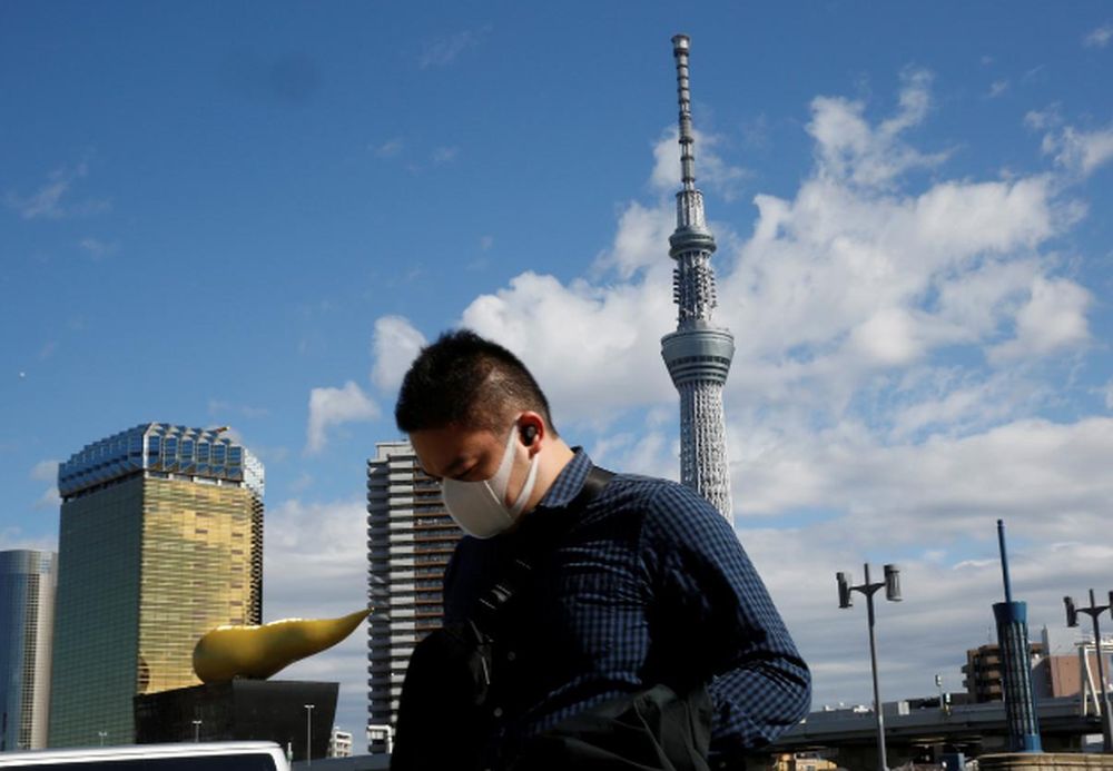 A man wearing a mask walks past Tokyo Sky Tree in Tokyo, Japan January 31, 2020. u00e2u20acu201d Reuters pic