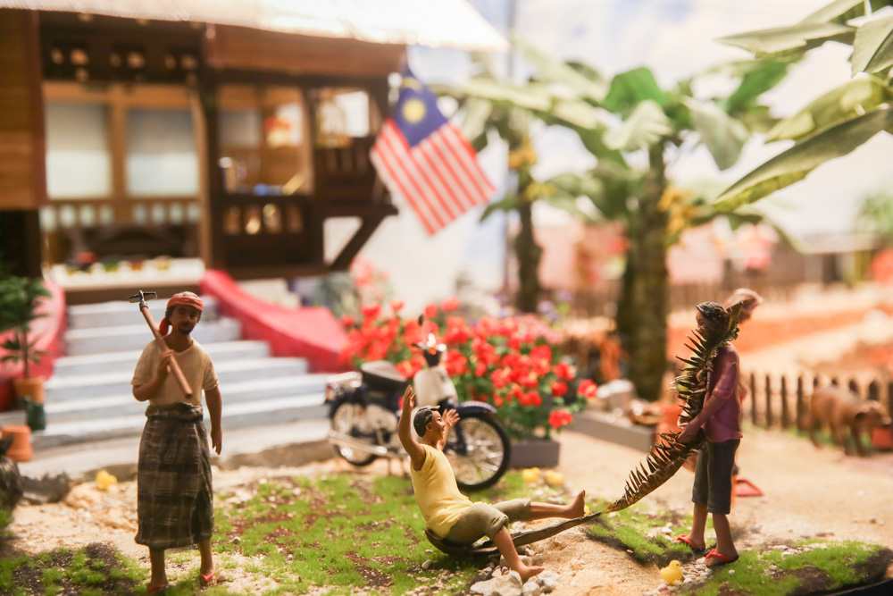 Spot the villagers playing a nostalgic game of u00e2u20acu02dctarik upihu00e2u20acu2122 (palm frond sledding) in one of MinNature Malaysiau00e2u20acu2122s richly-detailed dioramas. u00e2u20acu201d Picture by Choo Choy Mayn