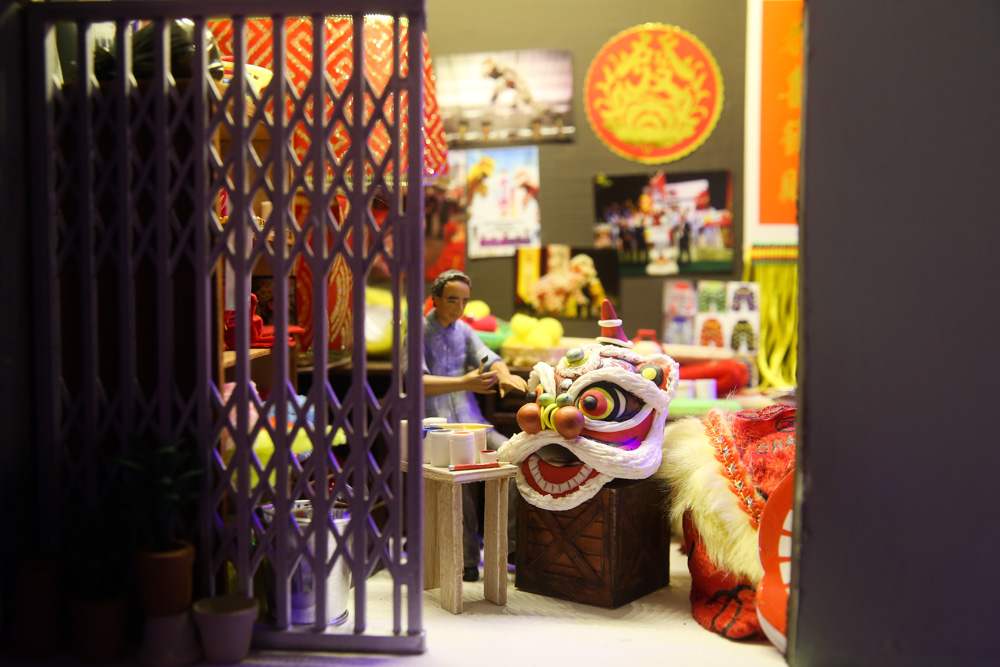 A tiny craftsman at work on a Chinese lion head. — Picture by Choo Choy May