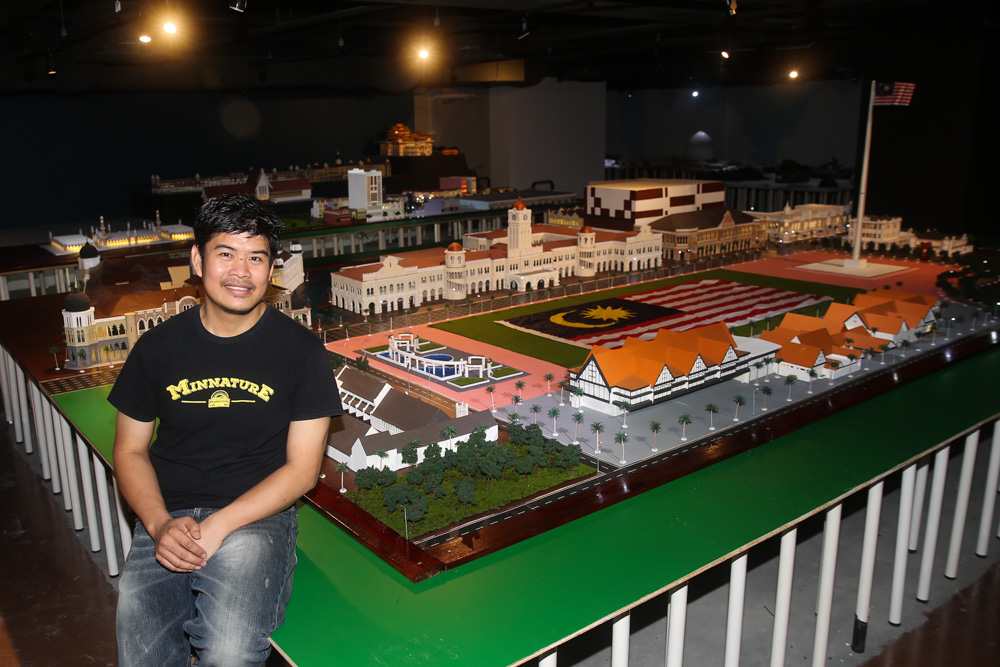 Wan with a model of Dataran Merdeka and its iconic landmarks such as the Sultan Abdul Samad Building and the Royal Selangor Club. — Picture by Choo Choy May