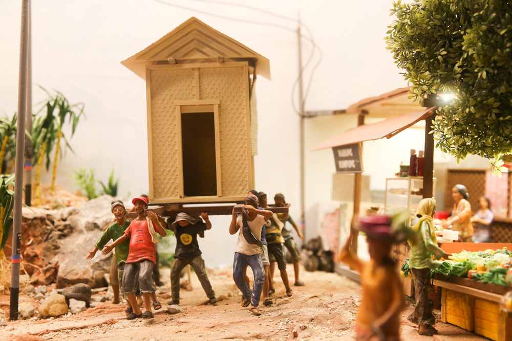 Small but mighty villagers lifting an entire house by hand, also known as the ‘angkat rumah’ tradition commonly practised by rural Malay communities. — Picture by Choo Choy May