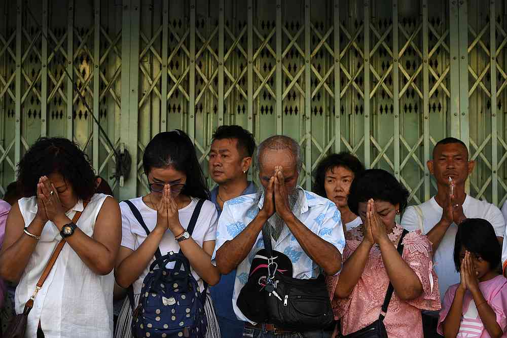 People react during a religious ritual to remember the victims of last week's mass shooting by a rogue soldier in Nakhon Ratchasima, Thailand February 15, 2020. u00e2u20acu201d Reuters pic